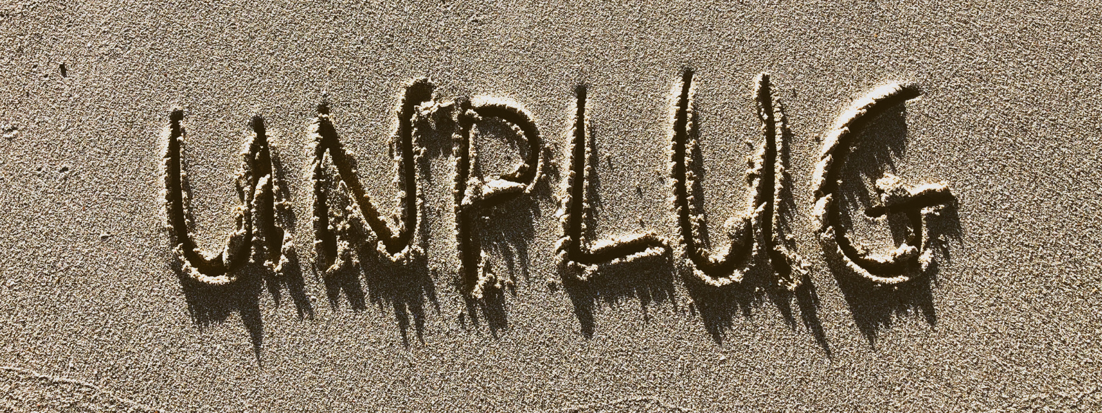 unplug_written_in_sand